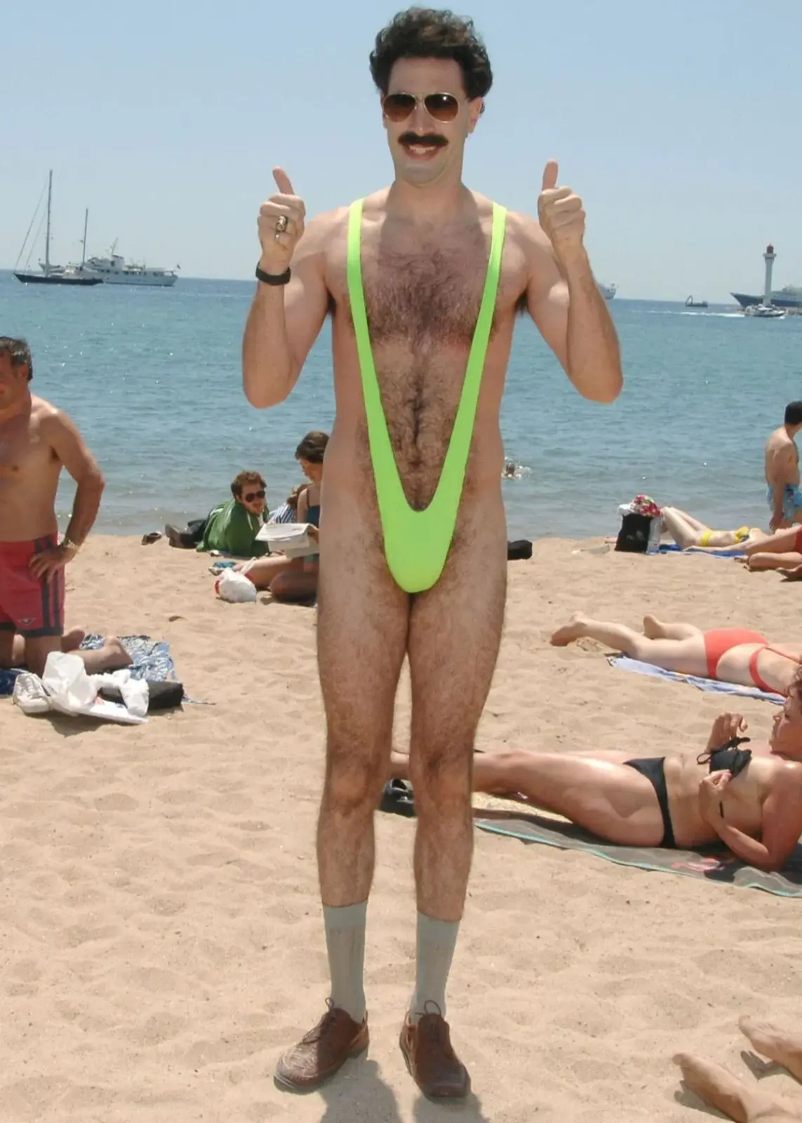 A person wearing a bright green monokini and giving thumbs up