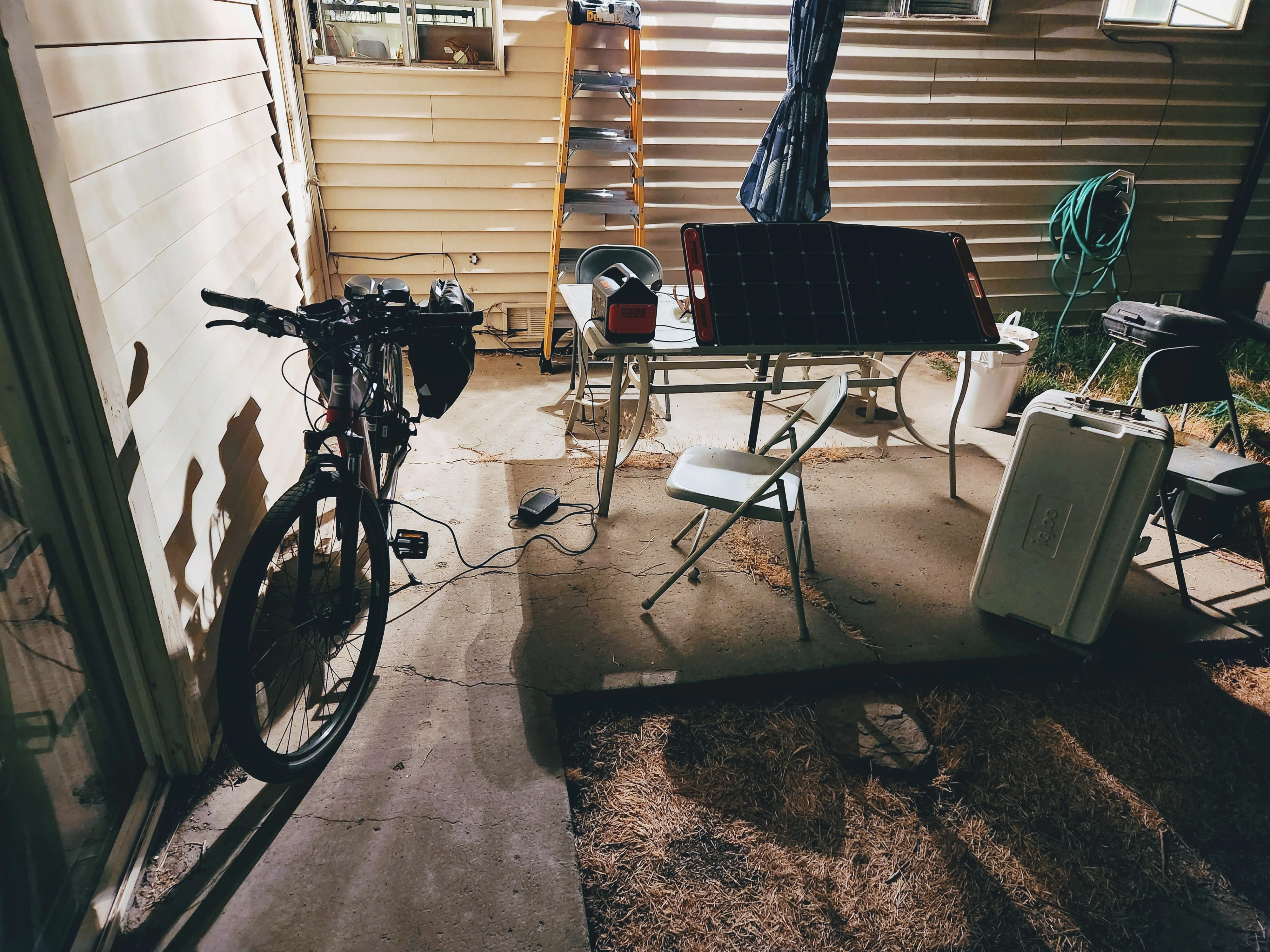 solar panel connected to Jackery generator charging an ebike.