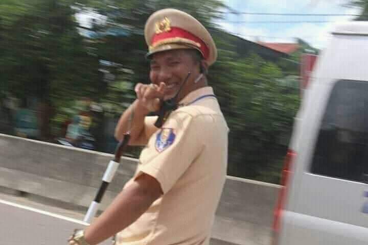 Smiling traffic officer pointing at camera