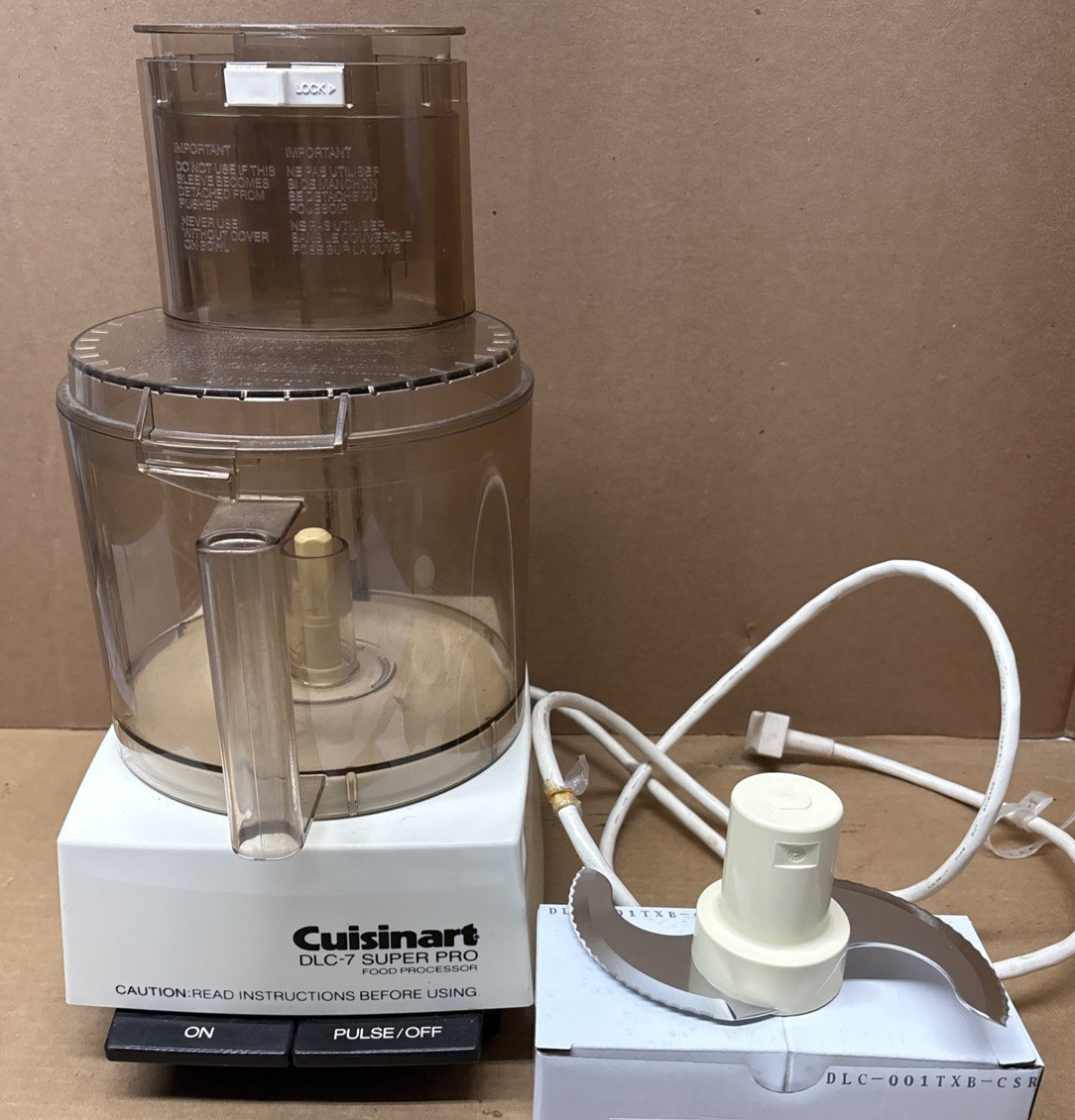 photo of a cuisinart 14-cup food processor DCL-7 Super Pro with a blade next to it