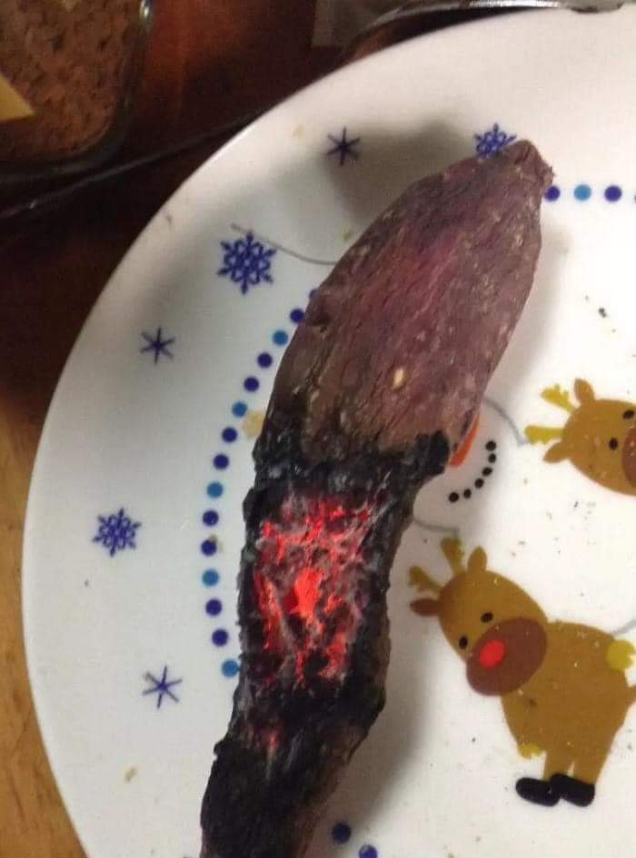 Sweet potato whose half is burnt to charcoal