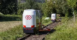 Self-balancing commuter pods ride old railway lines on demand