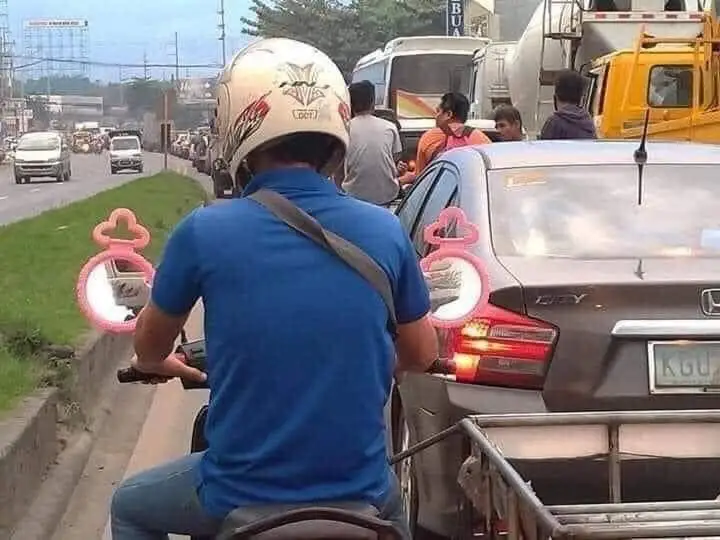 Motorcycle with mirrors replaced by handheld ones