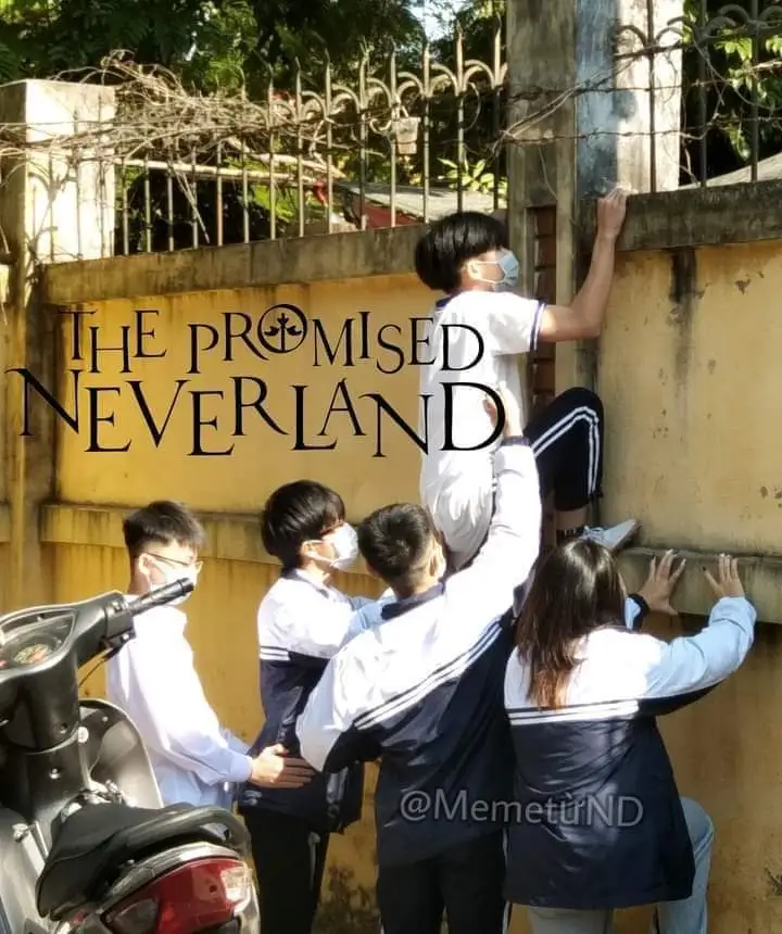 Students trying to climb the school's wall with razor wire on top