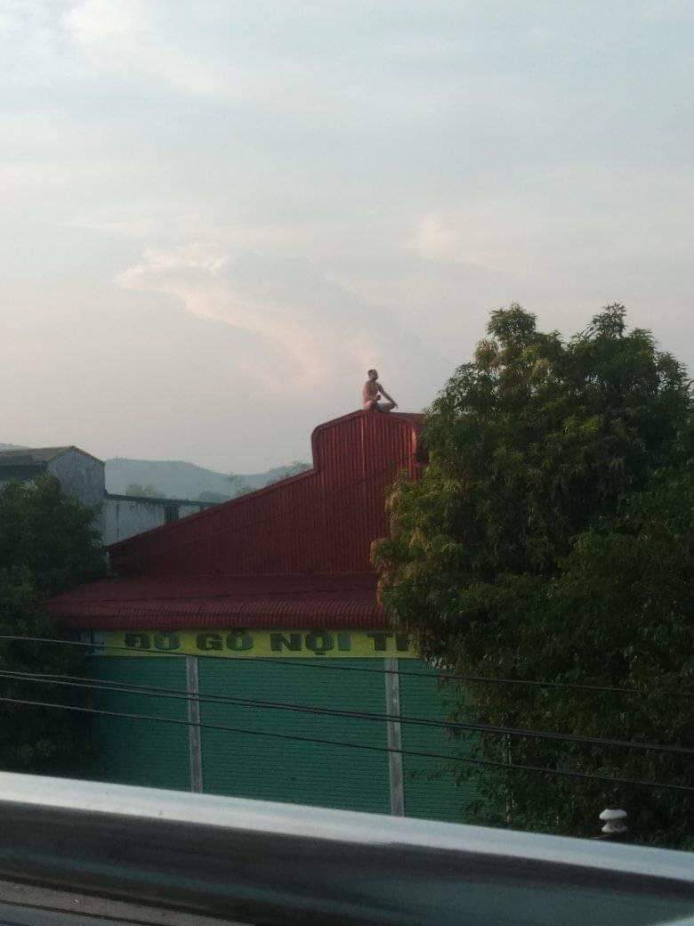 Person meditating on top of a roof